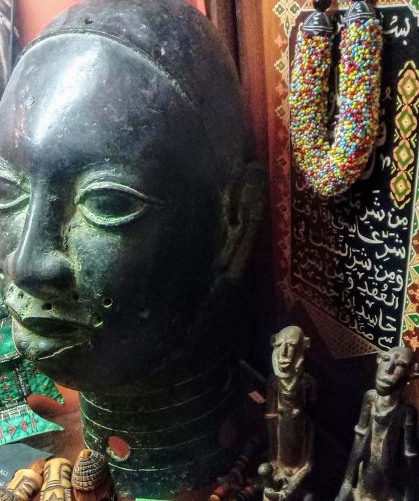 Yoruba bronze sculpture and Koran Plaque