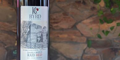 bottle of Byrd Cellars dahlgren's raid red with stone wall background
