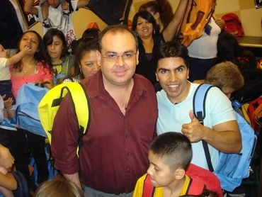 Two smiling men in a crowd