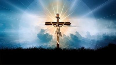 Jesus Christ crucified on the cross against a radiant sky.