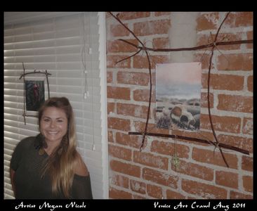 Artist Megan Nicole smiles beside her artwork at Venice Art Crawl, August 2011.