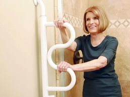 woman using security pole with curve grab bar in her bathroom