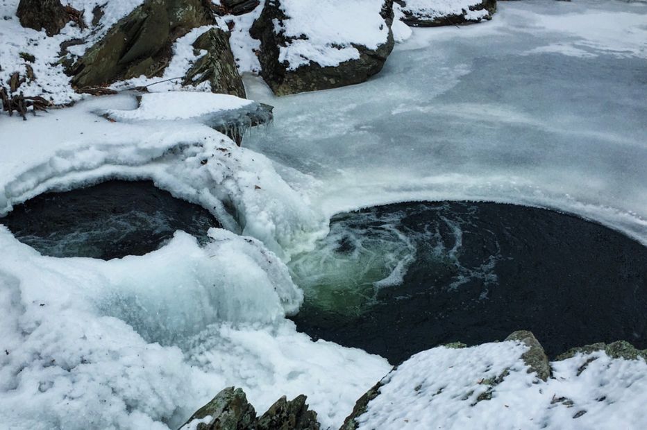 Side by side swimming holes surrounded by snow and ice. Water flows from the higher to the low creating a waterfall and enhancing this transcendent micro-forest setting. This all takes place due to intuitive landscape design.