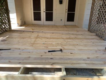 Homeowner wanted a wooden deck built on an existing concrete slab. He just had a patio cover install