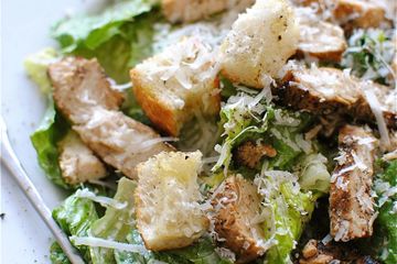 Caesar salad with iceberg lettuce croutons parmesan cheese and dressing