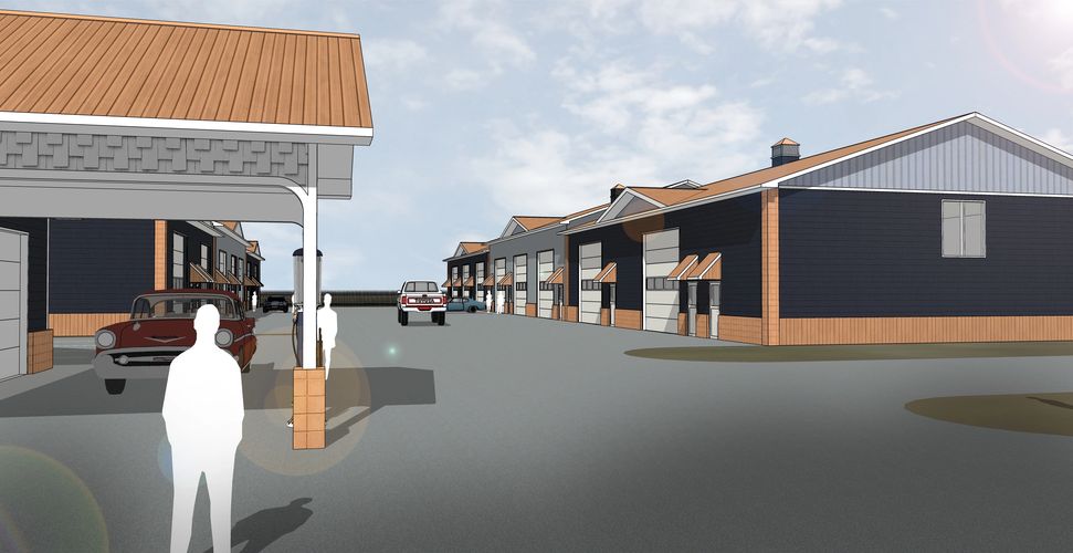 An eye-level view showing the fronts of two buildings, with vehicles and people to show scale.