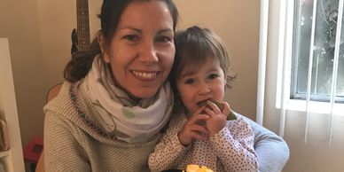 Mother and child eating a mango