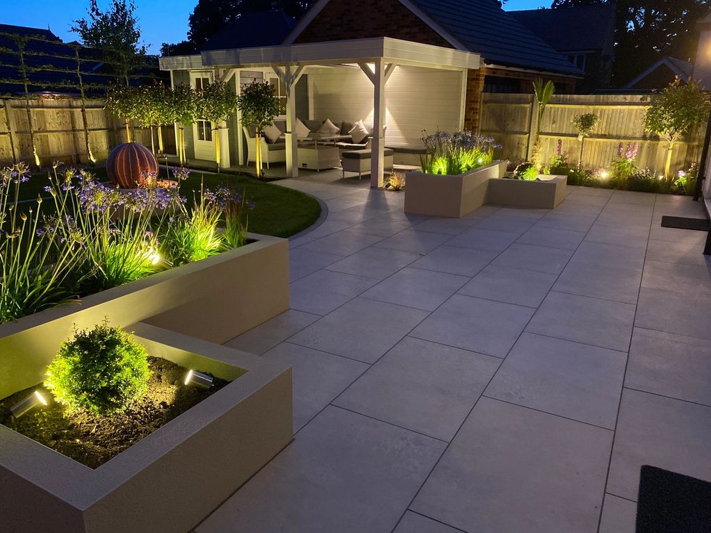 Garden Lighting at Night featuring a Outdoor Entertaining Area with Heating and Custom Water Feature