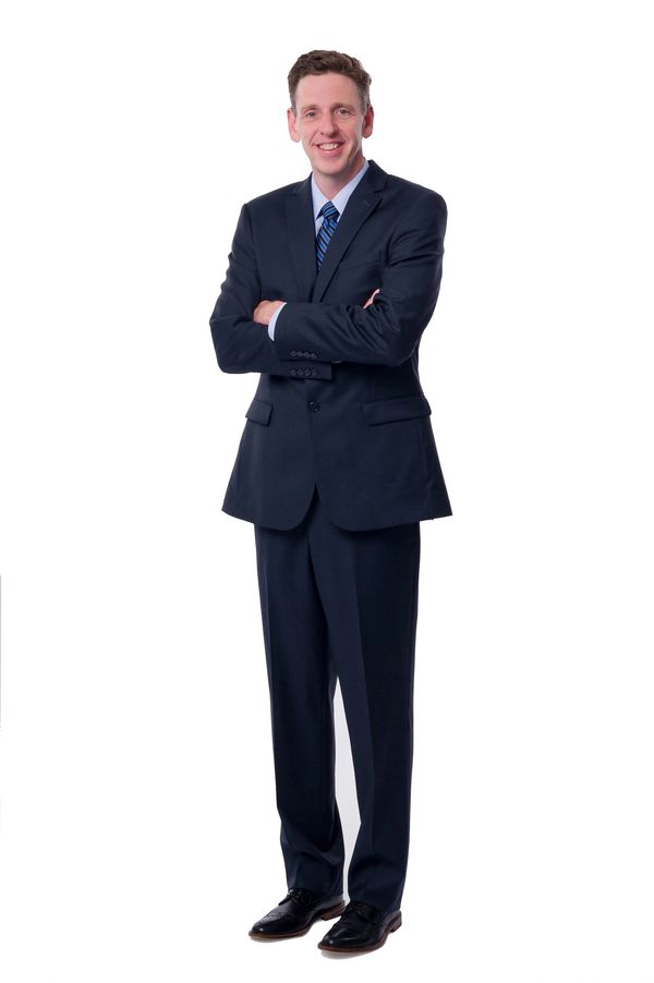 Bob Roark - standing arms crossed in a suit