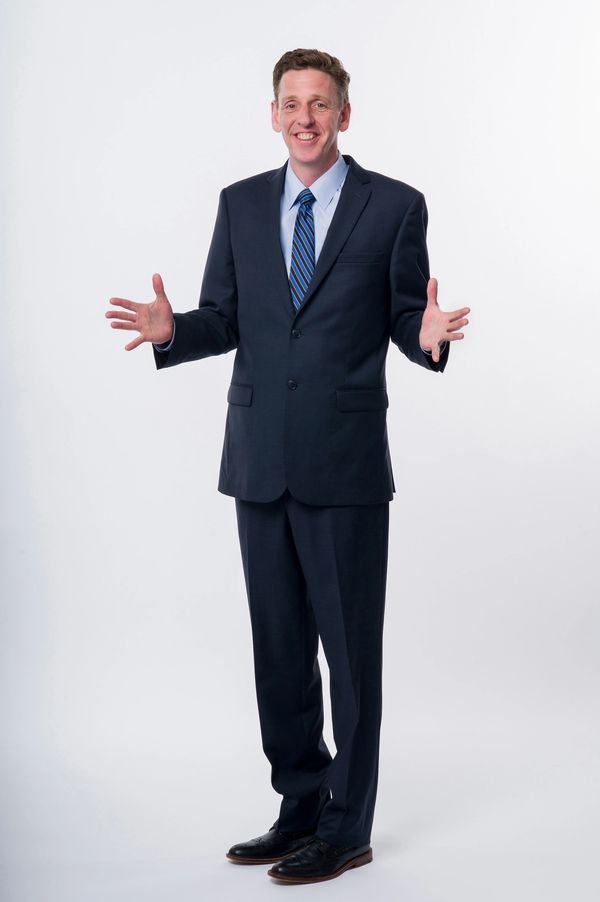 Bob Roark standing with arms open