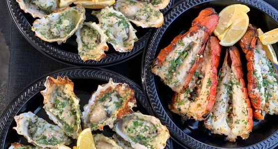 Garlic butter herb and cheese grilled oysters with lemon. Grilled garlic butter cold water lobster w