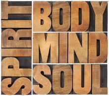 Wooden letters artistically arranged in the words Spirit, Body, Mind and Soul.
