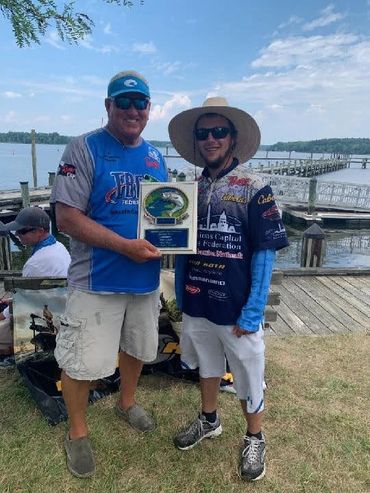 A man with Hold the certificate and take a picture another man