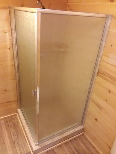 Framed corner shower door with obscured glass