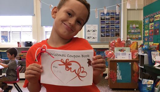 a kid with an "Aloha is Love" Coupon book