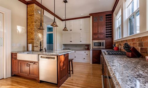 Modernized kitchen with wine rack and wine fridge. The original kitchen was in the basement.