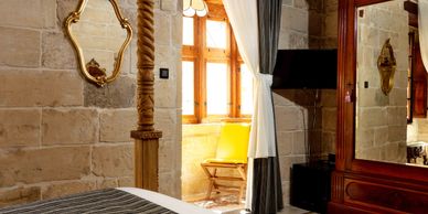 Luxury bedroom with four poster bed. Room d'Aragon at The 3Cities Auberge
