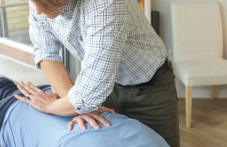 Dr. Liens woking on patient's back.