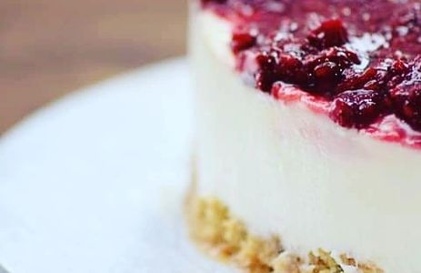 White chocolate and raspberry cheesecake on plate