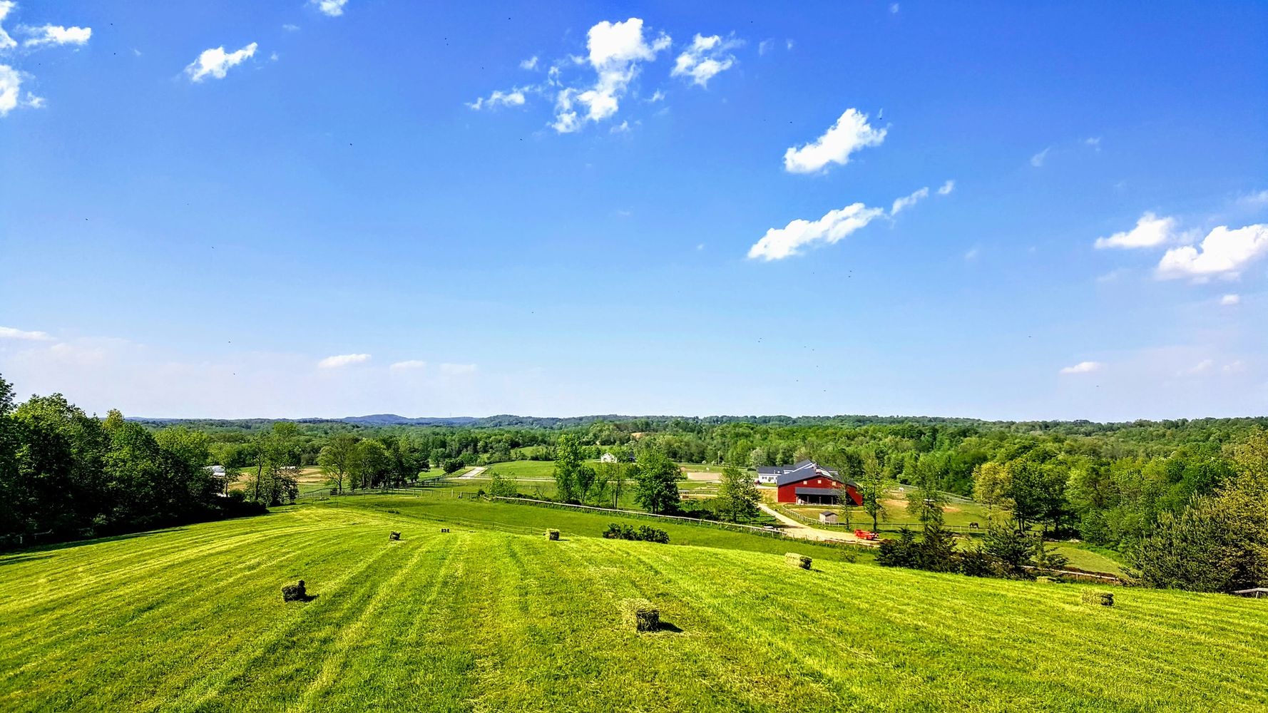 hay field with barn in the background