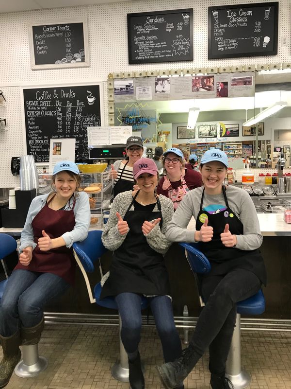 Image: happy soda clerks give double thumbs up at soda fountain  counter
