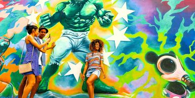 Tourists at Wynwood Walls taking pictures in front of the "Baby Hulk" mural, miami transfer tours
