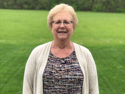 A woman standing in a lawn