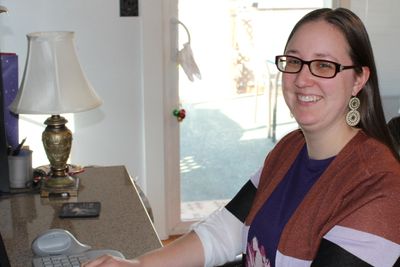 Editor Andrea Herrick working at her desk.