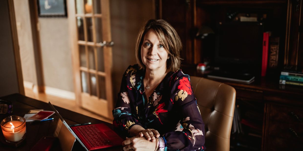a picture of Christine Panka, Grief Coach for InPerspective Life Coaching sitting at her desk.