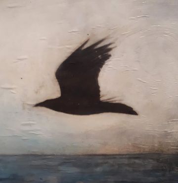 Raven flying against grey sky- mixed media/encaustic by Jyne Greenley