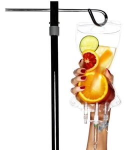 IV bag with fruit in it, woman's hand squeezing the bag