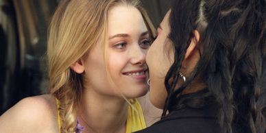 Girls smiling into kiss