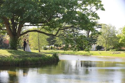 distance shot of bride and groom across a lake