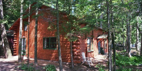 Woodsy quaint Higgins Lake waterfront log cabin makes for the perfect Michigan vacation destination up north