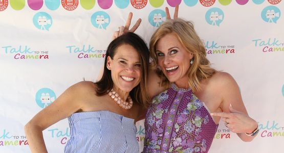 Photo of Our Co-Founders Jenny & Audrey, smiling and holding up rabbit ear fingers behind each other