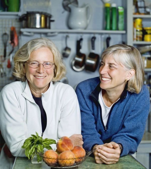 Middle age same-sex couple planning a meal in kitchen