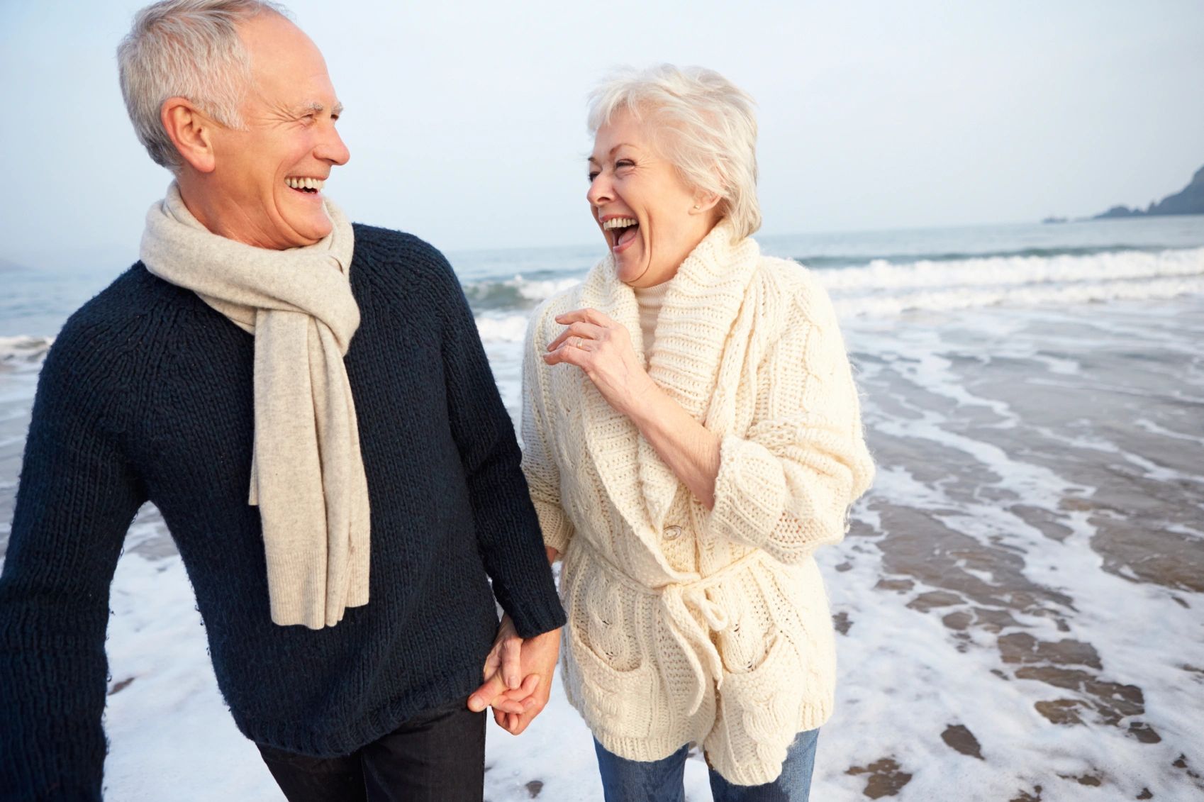 mature couple laughing on the beach