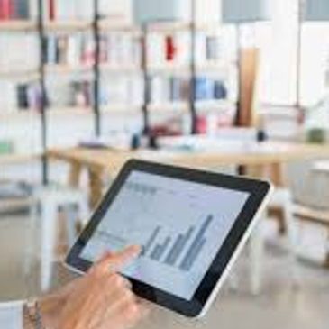 woman works with financials on tablet computer