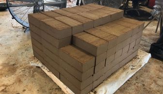 A stack of 6" x 12" compressed earth blocks