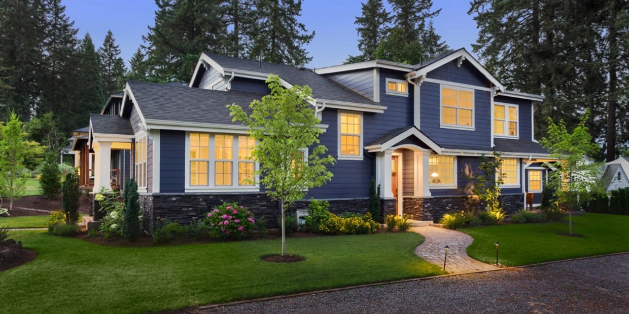 Beautiful landscaped home with fresh sod and flowers around edge of house.