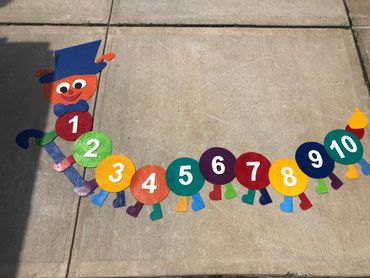 Preformed thermoplastic colorful number top hat caterpillar on concrete by surface signs of NY