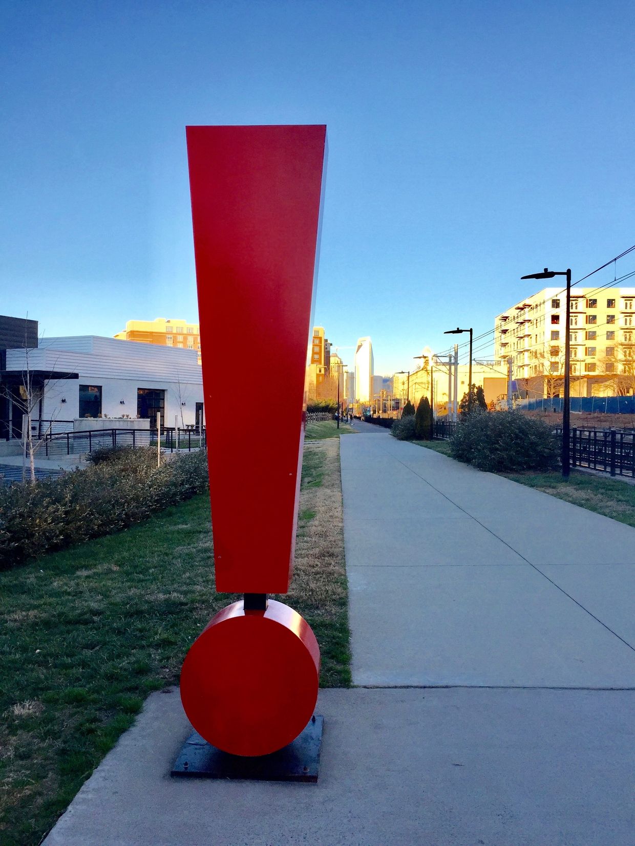 Sculpture of a red large scale exclamation point.