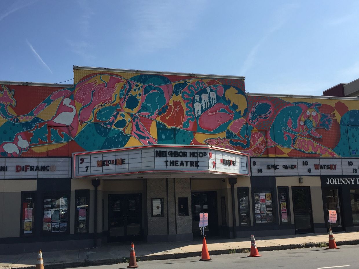 Mural of reds, turquoises, yellows, and pinks with different organic shapes and some animal shapes