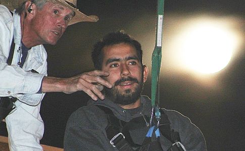 A zip liner getting instruction from a guide on how to shoot the targets.