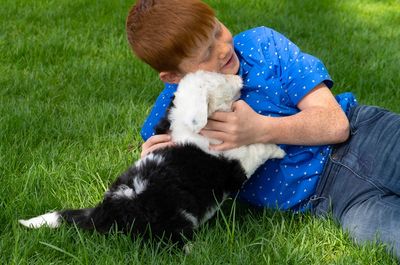 Boy with sheepadoodle puppy