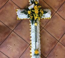 Funeral cross flowers in white and yellow