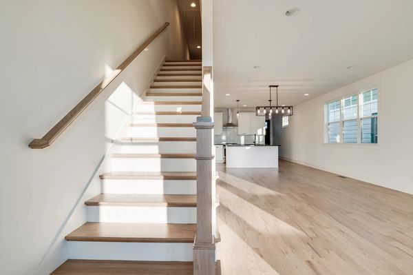 front entry with staircase and kitchen in background