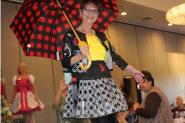 Photo of a Walnut Valley Women's Club member modeling the SGVD winning entry made completely from re