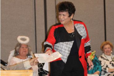 Photo of a club member being honored as Kindness Angel and the SGVD fashion show.