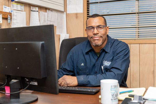A man sitting near his computer